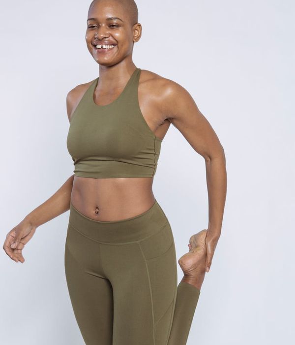 Happy woman doing light stretching exercises in a bright room.